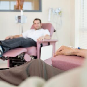 two people in chairs using iv's