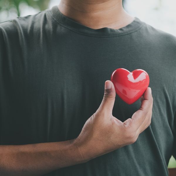 A man with a plastic heart across his chest