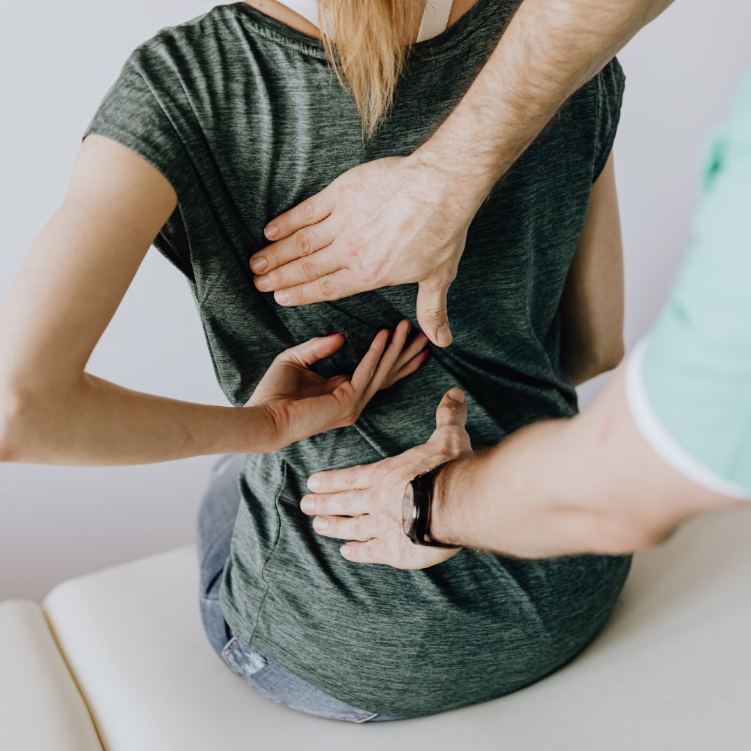 chiropractor feeling patient's back