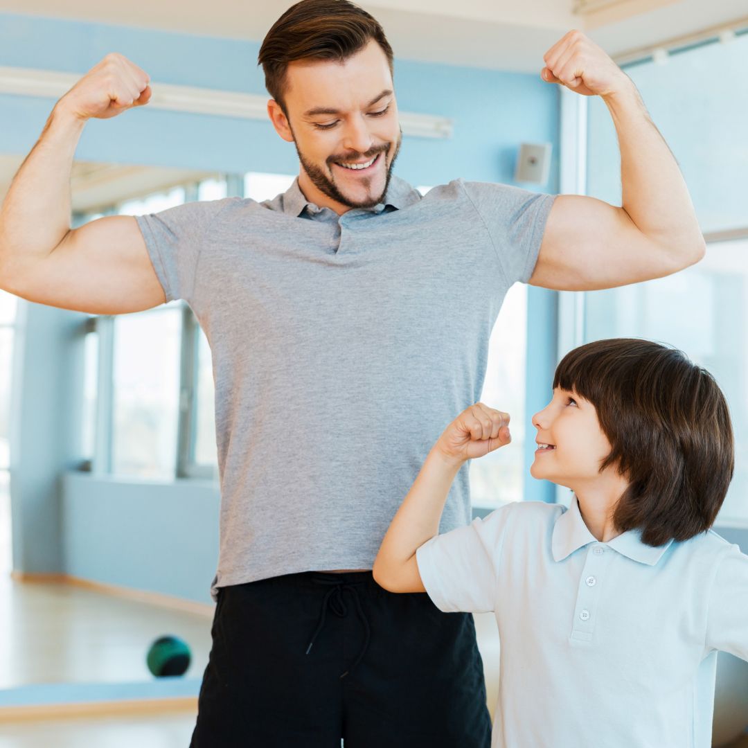 a father and son flexing their muscles