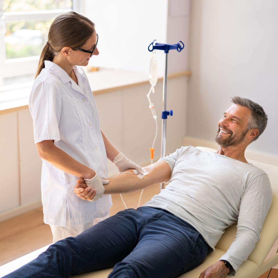 a nurse giving a man an IV