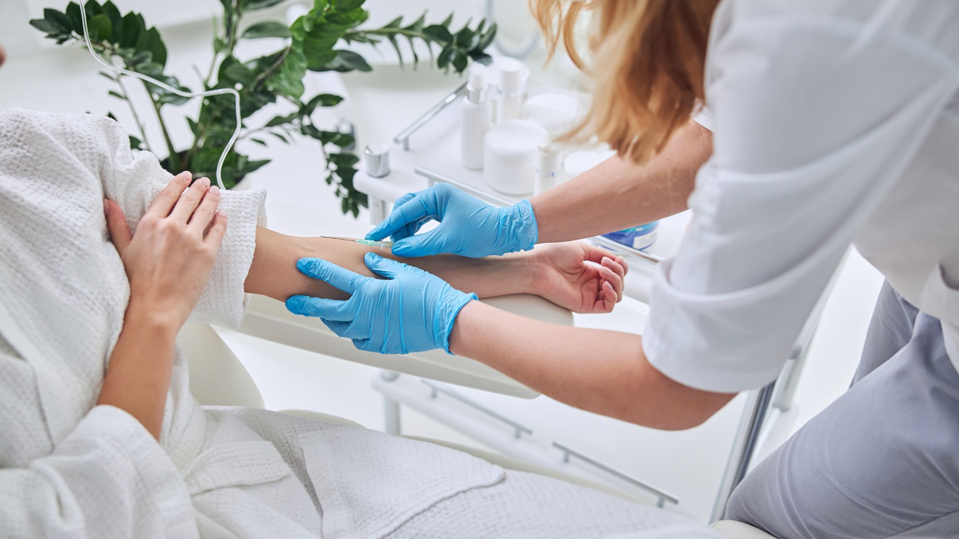 person getting IV placed in arm for IV therapy