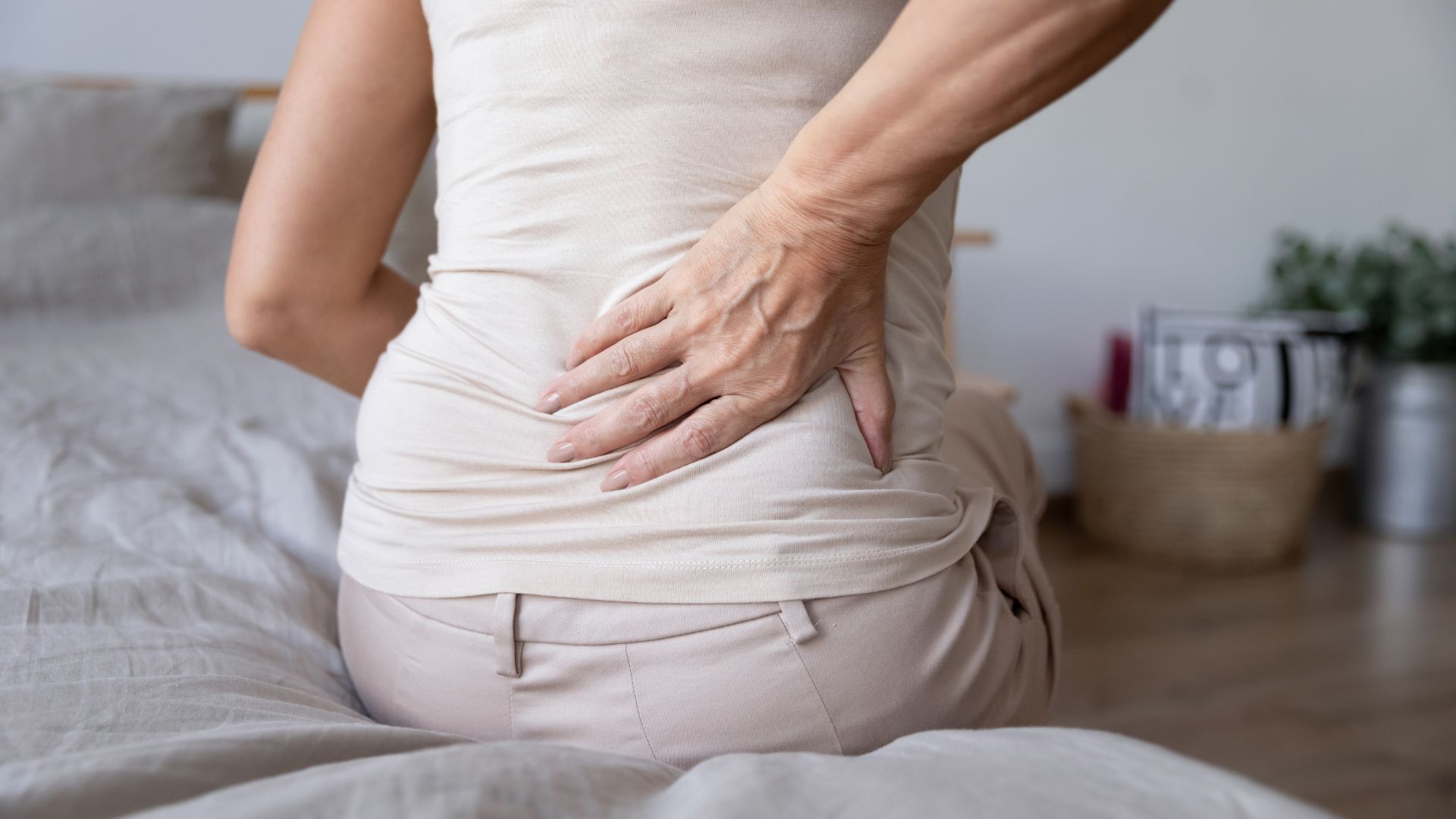woman holding lower back