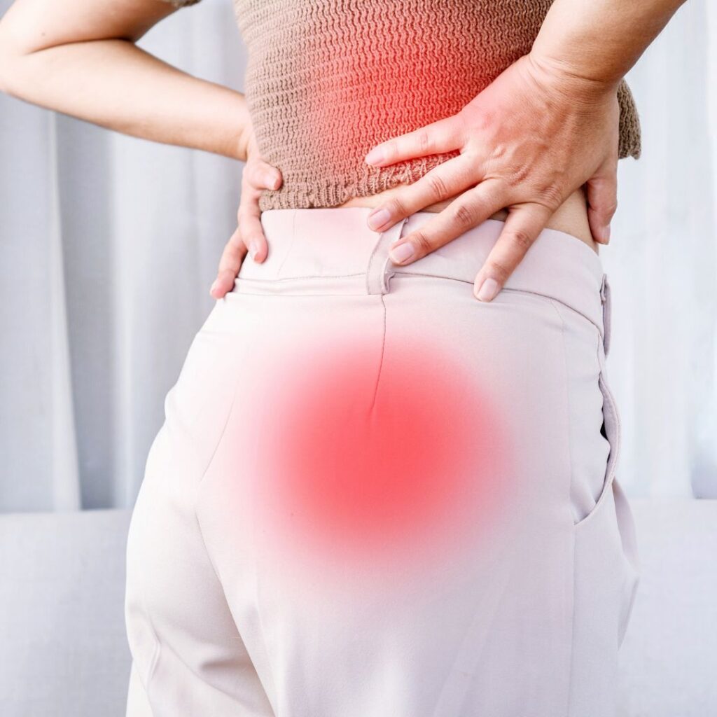 woman holding lower back in pain