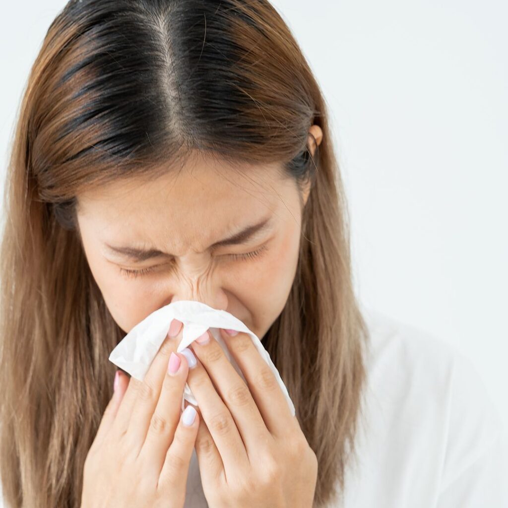 A woman sneezing