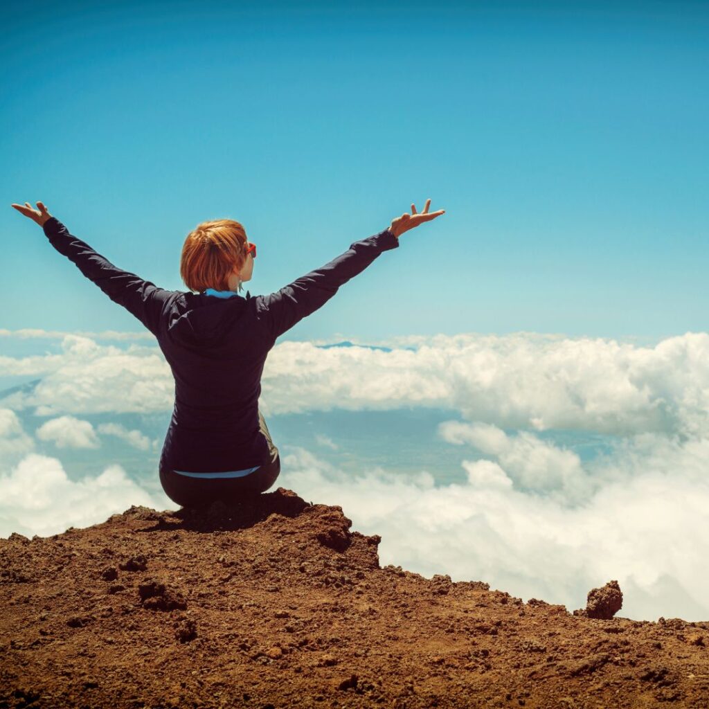 Happy person on top of mountain
