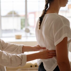 Chiropractor adjusts woman's back