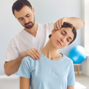 Chiropractor adjusts woman's neck