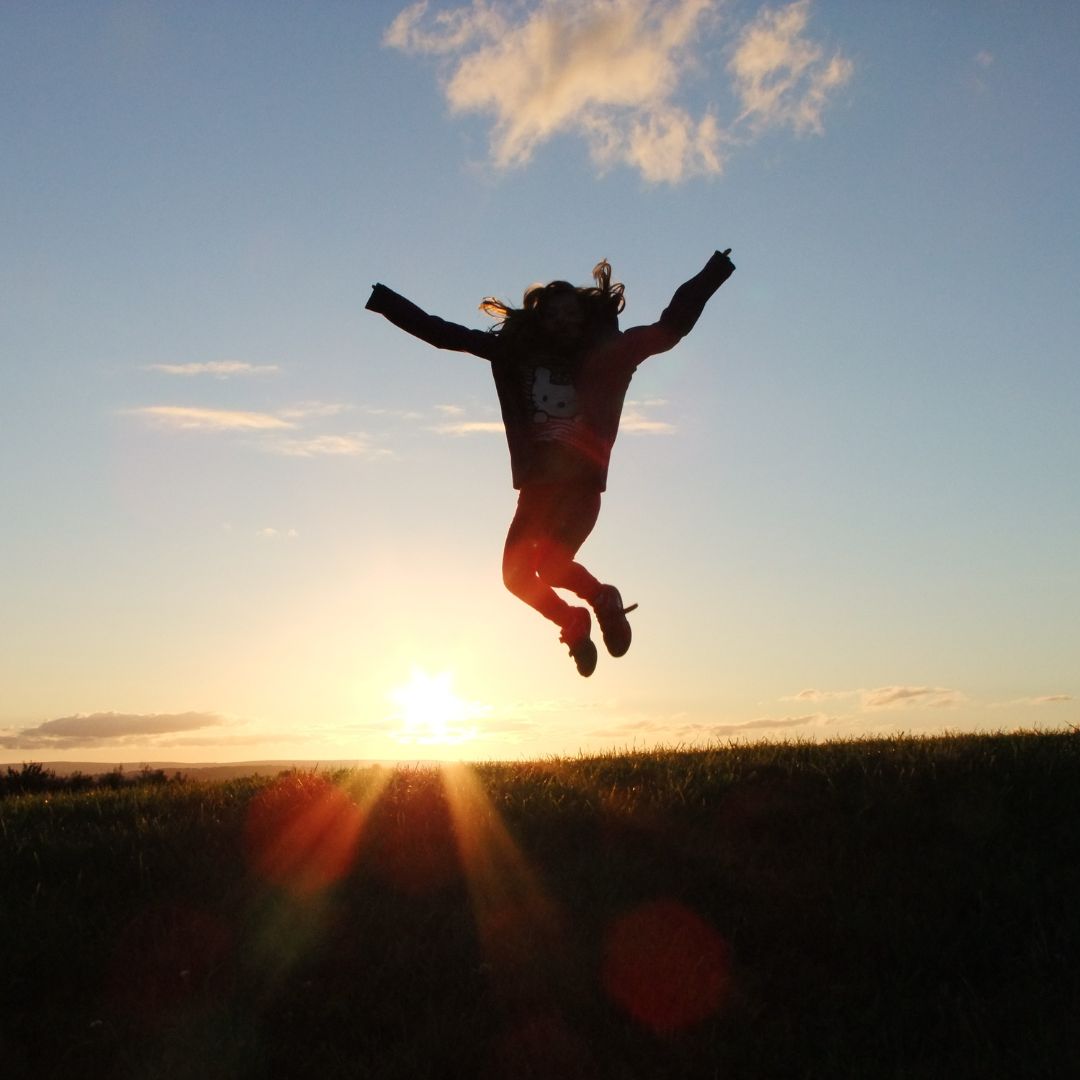 Photo of a woman jumping, symbolizing being happy and healthy