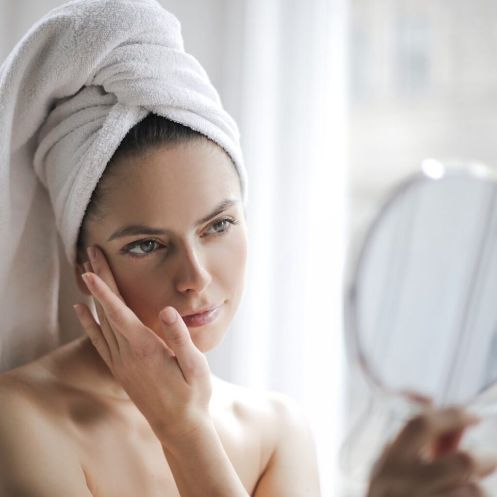 a woman admiring her skin