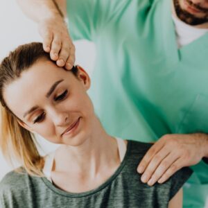 a chiropractor is adjusting a woman's neck