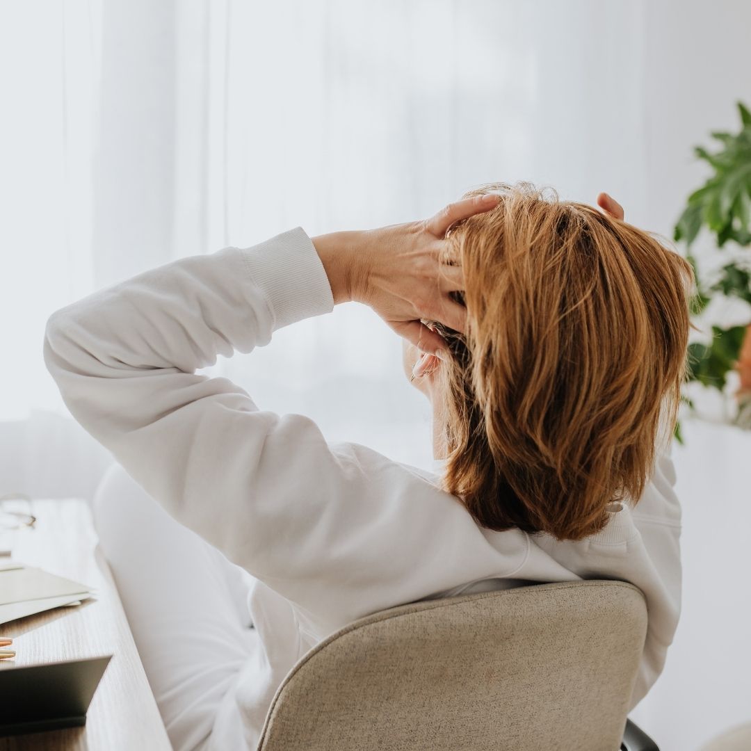 woman rubbing head