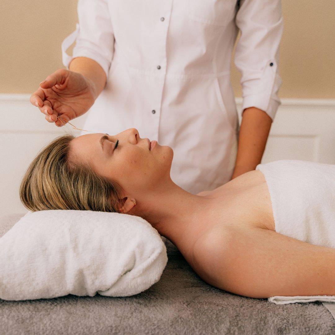woman receiving acupuncture treatment